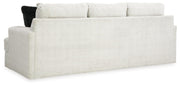 Ashley Furniture Karinne Sofa with plush cushions and rolled arms, shown from the back in this stylish living room setting.