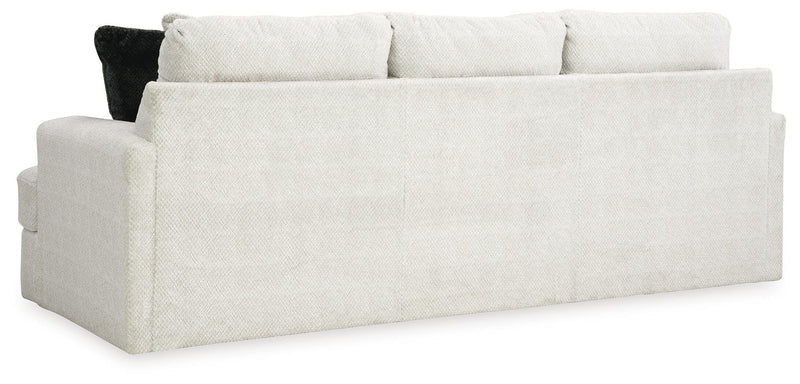 Ashley Furniture Karinne Sofa with plush cushions and rolled arms, shown from the back in this stylish living room setting.
