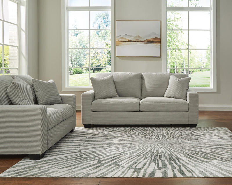Ashley Furniture Greenbriar living room set with sofa and loveseat featuring green upholstery and plush cushions.