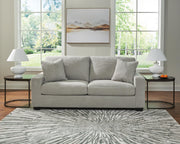 Greenbriar Ashley Furniture living room set with sofa and armchair, featuring green upholstery and wooden legs.