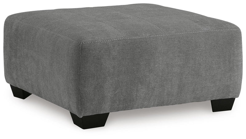 Ashley Furniture Birkdale Court oversized accent ottoman with plush fabric and square shape, shown from an angled view.