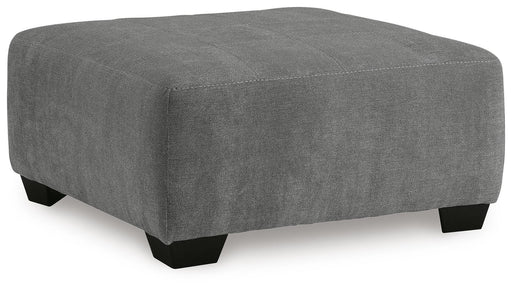 Ashley Furniture Birkdale Court oversized accent ottoman with plush fabric and square shape, shown from an angled view.