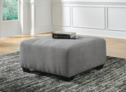 Oversized Ashley Furniture Birkdale Court accent ottoman with plush fabric and tufted top, versatile for living room decor.