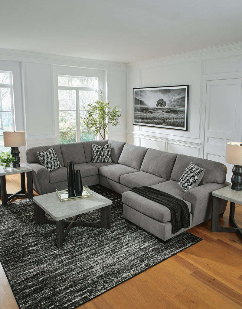 Ashley Furniture Birkdale Court sectional with chaise, beige fabric, plush cushions, and modern design in a spacious living room.