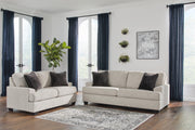 Ashley Furniture Vayda living room set with sofa and armchair, featuring neutral upholstery and modern design.