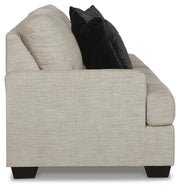 Ashley Furniture Vayda living room set featuring a sofa and loveseat in neutral upholstery, stylishly arranged in a modern living space.