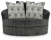Ashley Furniture Biddeford oversized swivel accent chair with plush fabric, tufted back, and wooden base in a modern living room setting.
