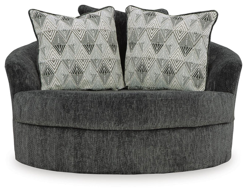 Ashley Furniture Biddeford oversized swivel accent chair with plush fabric, tufted back, and wooden base in a modern living room setting.