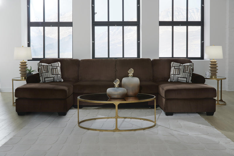 Ashley Furniture Kimlee sectional with double chaise, featuring plush cushions and modern design in a spacious living room setting.