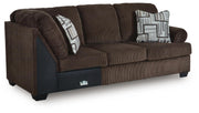 Ashley Furniture Kimlee sectional with chaise, featuring plush upholstery and a modern L-shaped design, shown from an angle.