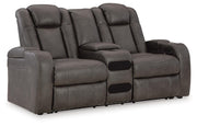 Ashley Furniture Fyne-Dyme power reclining loveseat with console, showing plush upholstery and reclining features from an angled view.