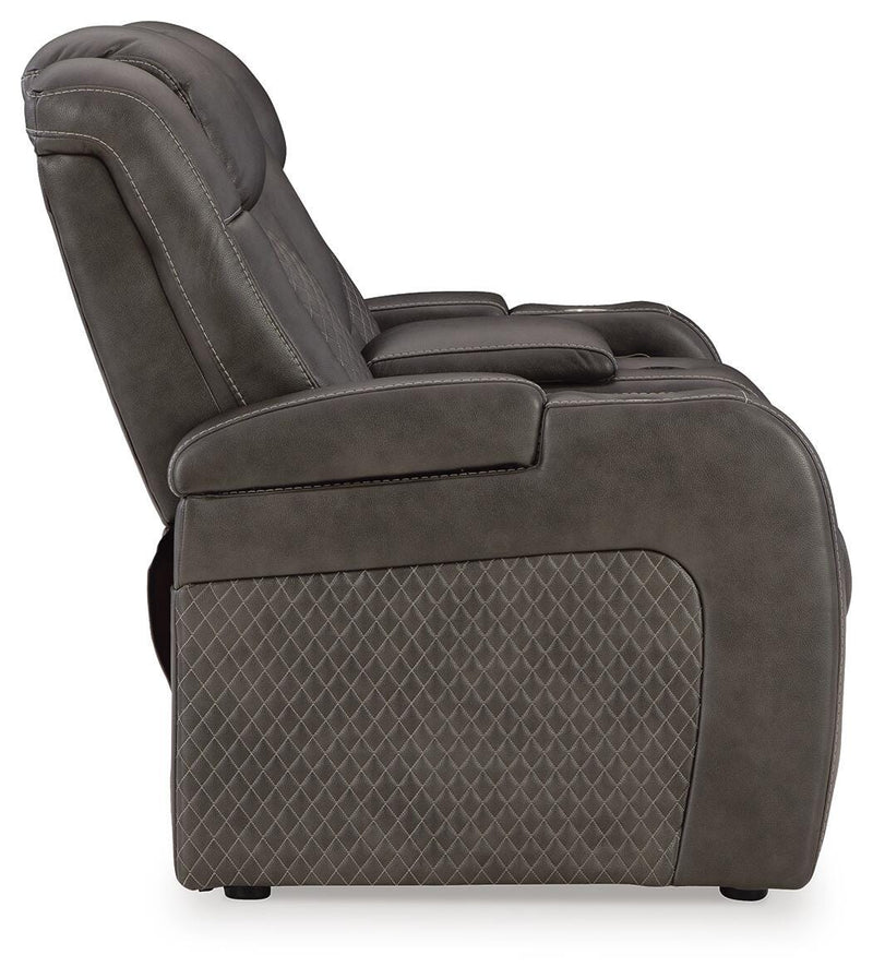 Ashley Furniture Fyne-Dyme power reclining loveseat with console, showing plush fabric, reclining mechanism, and built-in cup holders.