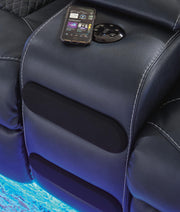 Ashley Furniture Fyne-Dyme power reclining loveseat with console, featuring plush blue upholstery and built-in Bluetooth audio system.
