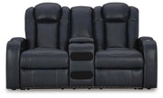 Ashley Furniture Fyne-Dyme power reclining loveseat with console, showing plush fabric, reclining mechanism, and built-in storage armrest.