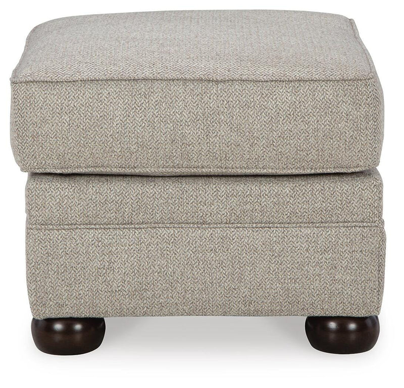 Ashley Furniture Gaelon Ottoman featuring a plush fabric and modern design, shown from a side angle.
