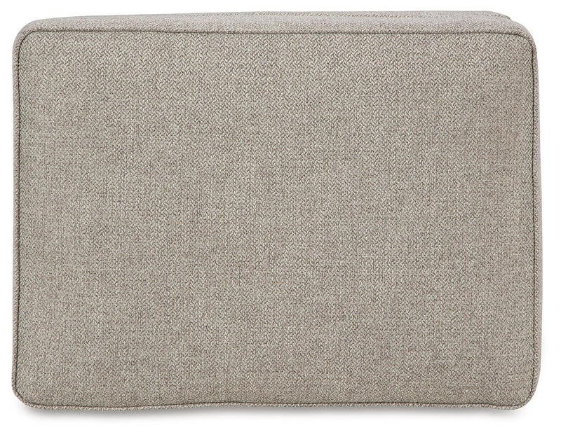 Ashley Furniture Gaelon Ottoman with soft fabric top and wooden legs, stylish and versatile for living room decor.