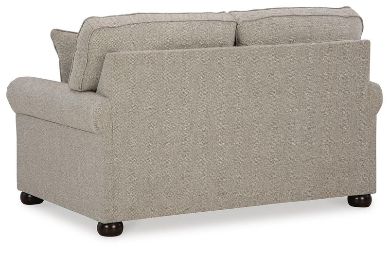 Ashley Furniture Gaelon loveseat with plush cushions and wooden legs, shown from the back in a cozy living room setting.