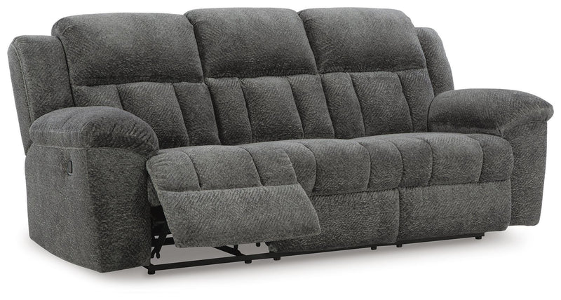 Ashley Furniture Frohn reclining sofa with plush cushions and extended footrest, shown from an angled open view.