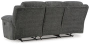 Ashley Furniture Frohn reclining sofa shown from the back, featuring plush upholstery and a built-in reclining mechanism.