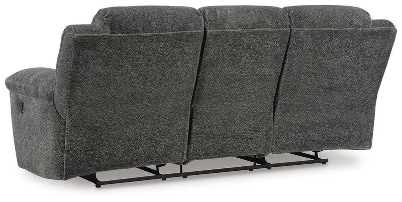 Ashley Furniture Frohn reclining sofa shown from the back, featuring plush upholstery and a built-in reclining mechanism.