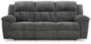 Ashley Furniture Frohn reclining sofa with plush cushions and dark upholstery, shown from a front head-on view.