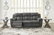 Open view of Ashley Furniture Frohn reclining sofa showing plush cushions and reclining feature in a modern living room setting.