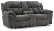 Ashley Furniture Frohn reclining loveseat with console, featuring plush upholstery and built-in cup holders, shown from an angled view