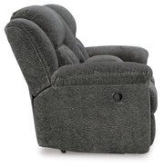 Ashley Furniture Frohn reclining loveseat with console, showing plush fabric, padded armrests, and built-in center console.