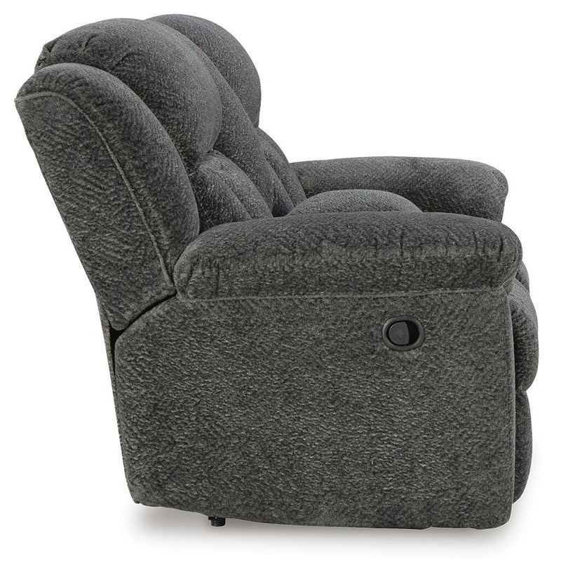 Ashley Furniture Frohn reclining loveseat with console, showing plush fabric, padded armrests, and built-in center console.