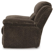 Ashley Furniture Frohn recliner with plush cushioning and wooden legs, shown from the side in a cozy living room setting.