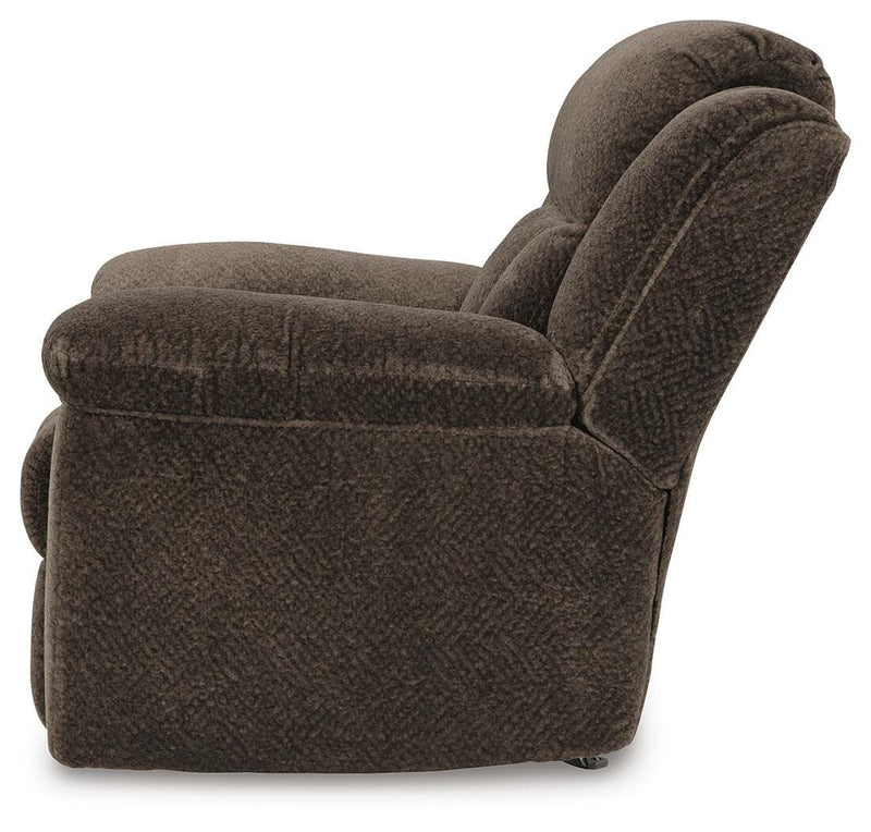 Ashley Furniture Frohn recliner with plush cushioning and wooden legs, shown from the side in a cozy living room setting.