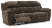 Ashley Furniture Frohn reclining sofa shown from an angled open view, showcasing plush cushions and reclining feature.