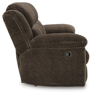 Ashley Furniture Frohn reclining sofa with plush cushions and wide armrests, shown in a relaxed seated position.