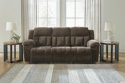 Ashley Furniture Frohn reclining sofa with plush cushions and modern design, shown in a comfortable, stylish living room setting.