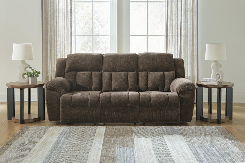 Ashley Furniture Frohn reclining sofa with plush cushions and modern design, shown in a comfortable, stylish living room setting.