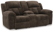 Ashley Furniture Frohn reclining loveseat with console, featuring plush fabric, cushioned armrests, and built-in cup holders.