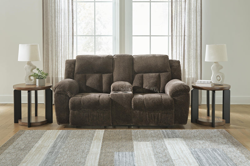 Ashley Furniture Frohn reclining loveseat with built-in console, plush fabric, and cushioned armrests for comfortable seating.