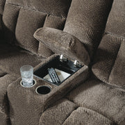 Close-up of Ashley Furniture Frohn reclining loveseat with built-in console and plush fabric upholstery.