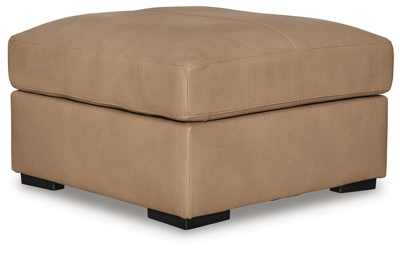 Ashley Furniture Bandon oversized accent ottoman with plush fabric and contemporary design, shown from an angled view.