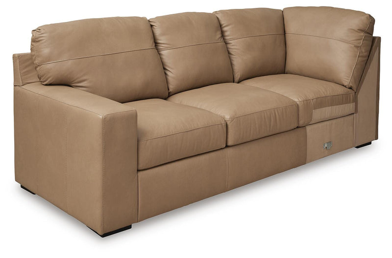 Ashley Furniture Bandon sectional sofa shown from an angled side view, featuring plush cushions and modern design.