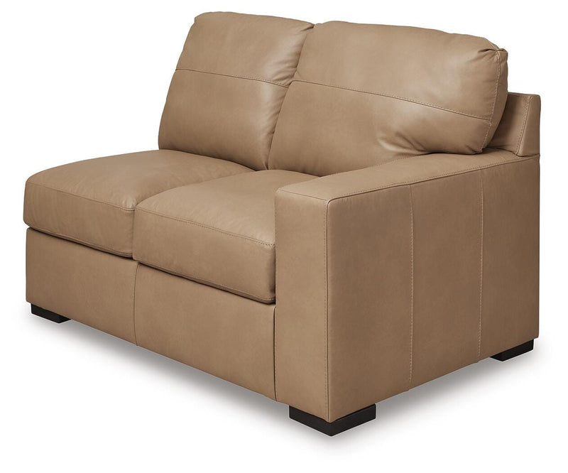Ashley Furniture Bandon sectional sofa with plush cushions and modern design, shown from an angled view.