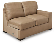 Ashley Furniture Bandon sectional sofa shown from an angle with neutral upholstery and plush cushions in a modern living room setting.