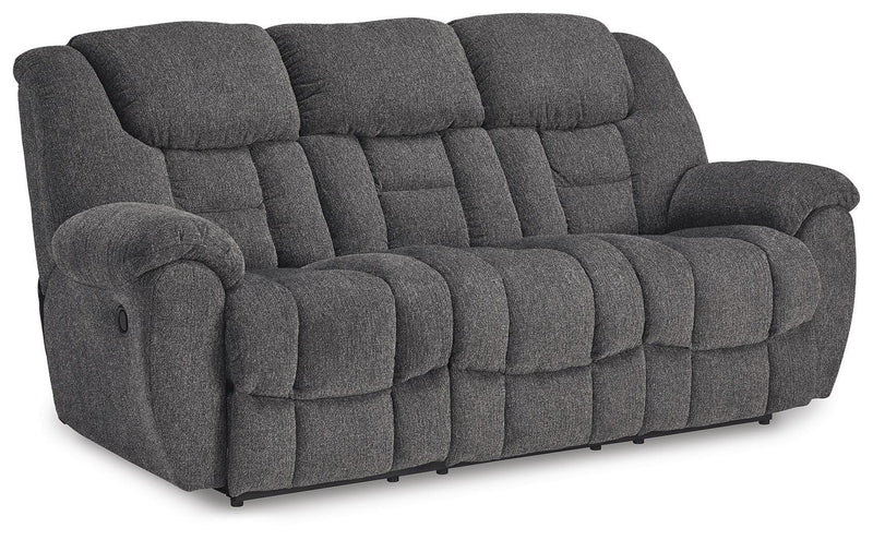 Ashley Furniture Foreside Reclining Sofa in a stylish fabric, shown from an angled side view with the reclined feature visible.
