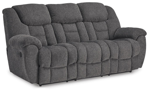 Ashley Furniture Foreside Reclining Sofa in a stylish fabric, shown from an angled side view with the reclined feature visible.