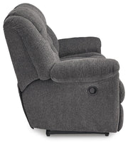Ashley Furniture Foreside Reclining Sofa with plush cushions and modern design, shown from the side.