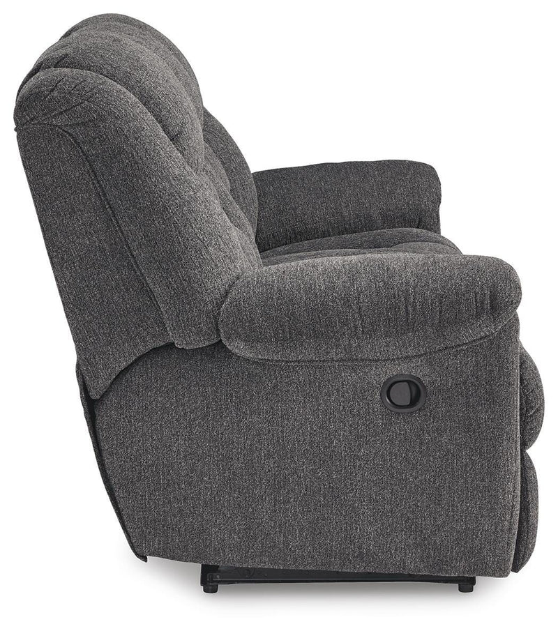 Ashley Furniture Foreside Reclining Sofa with plush cushions and modern design, shown from the side.