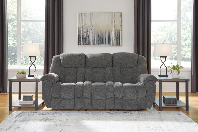 Ashley Furniture Foreside Reclining Sofa with plush cushions and reclining features, shown in a modern living room setting.