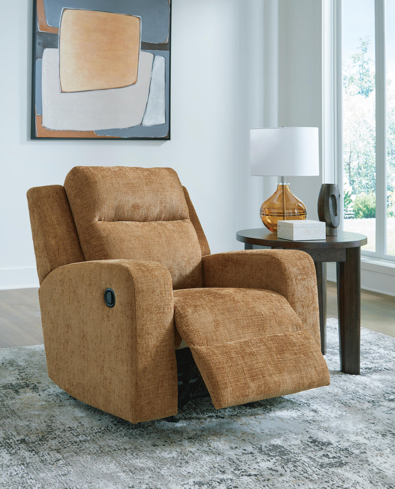 Open Ashley Furniture Kanlow recliner showing plush fabric upholstery and padded armrests in a cozy living room setting.