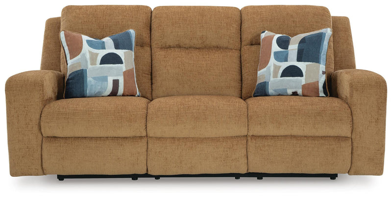 Ashley Furniture Kanlow reclining sofa with plush cushions and fabric upholstery, shown from the head-on angle.