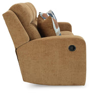 Ashley Furniture Kanlow reclining sofa with plush cushions and neutral fabric, shown from a side angle.